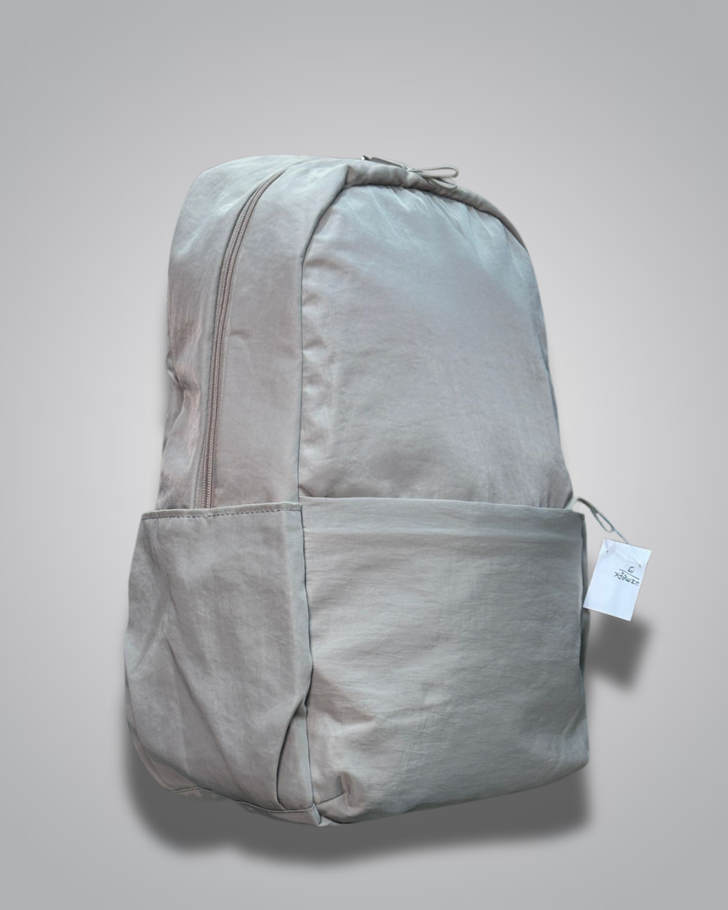Gray backpack with a tag on a light gray background- valentini impex