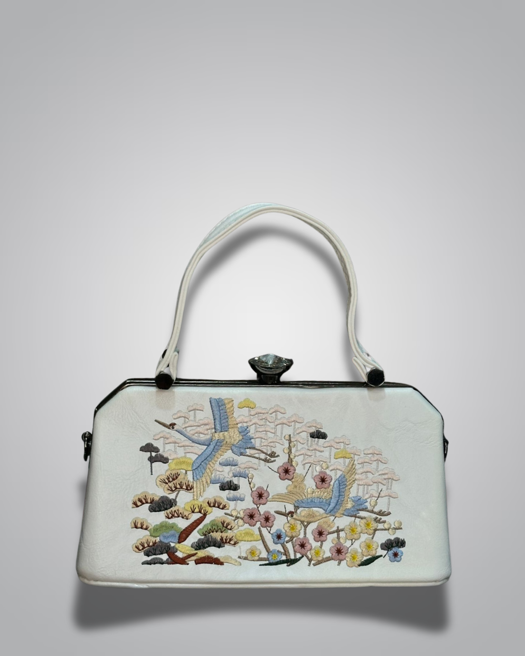 Embroidered handbag with floral and bird design on a light gray background- Valentino Impex