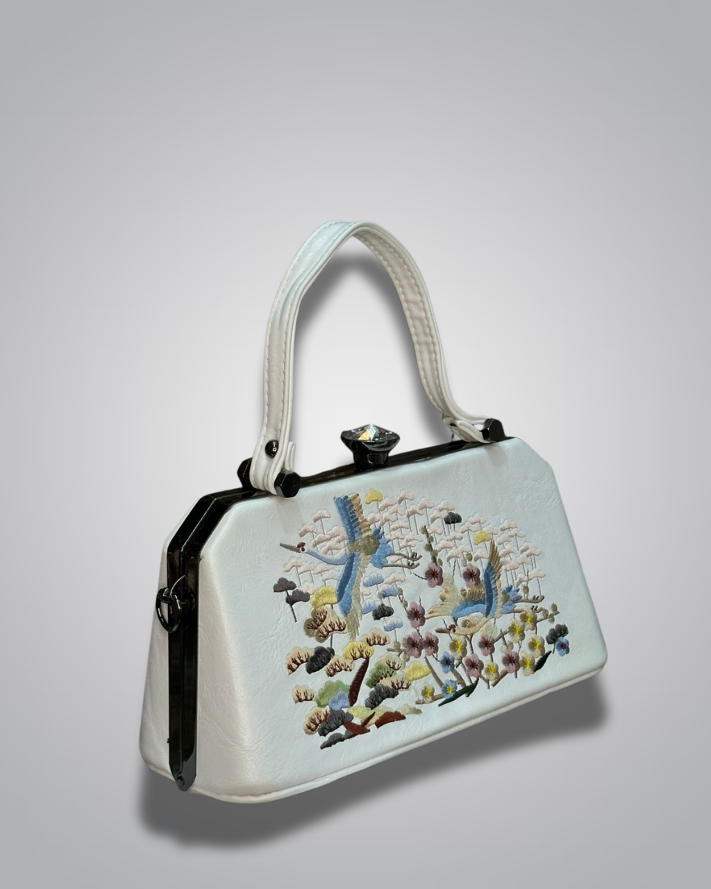 Embroidered handbag with floral and bird design on a light gray background- Valentino Impex