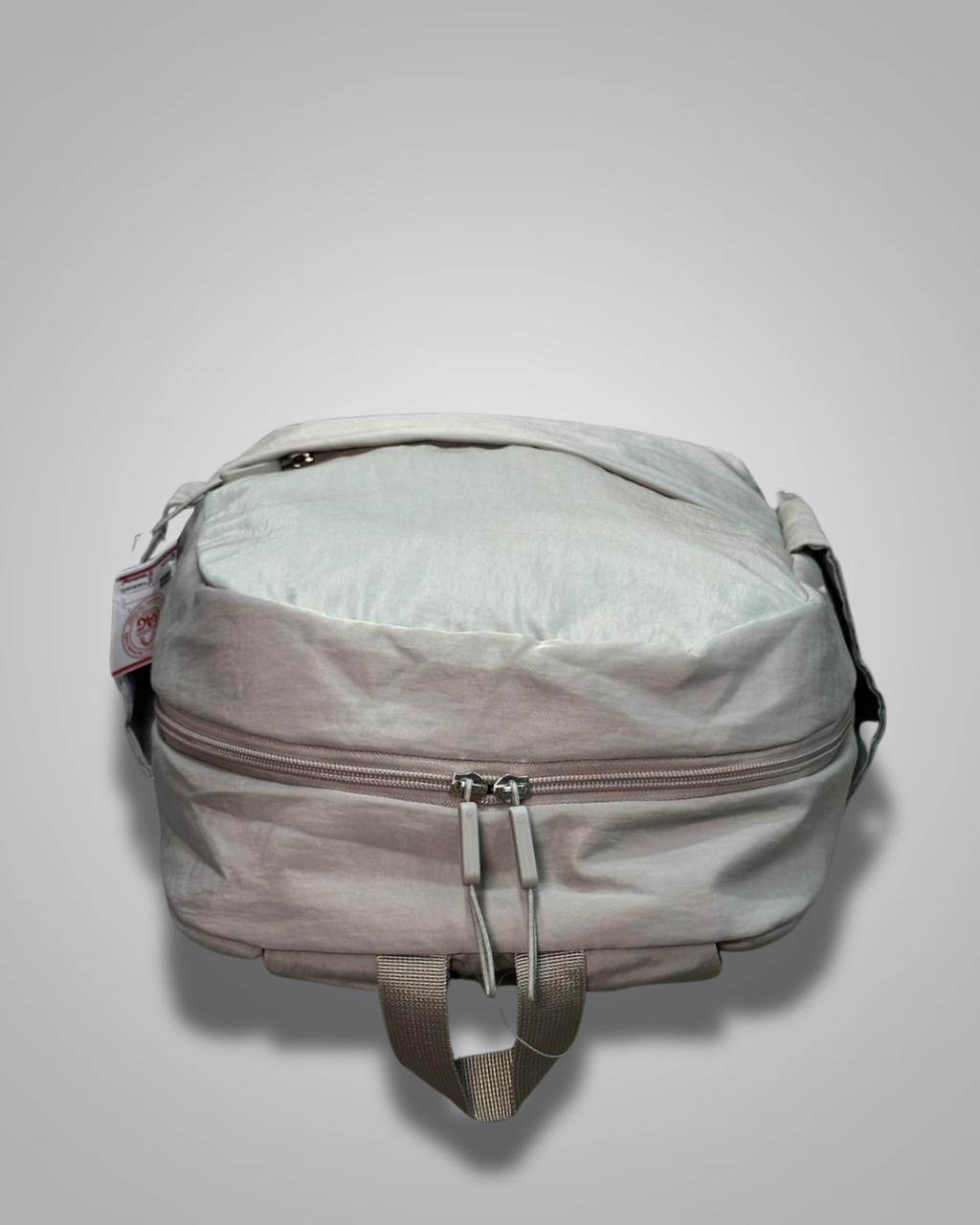 Light gray backpack with a visible brand tag on a light gray background- valentini impex