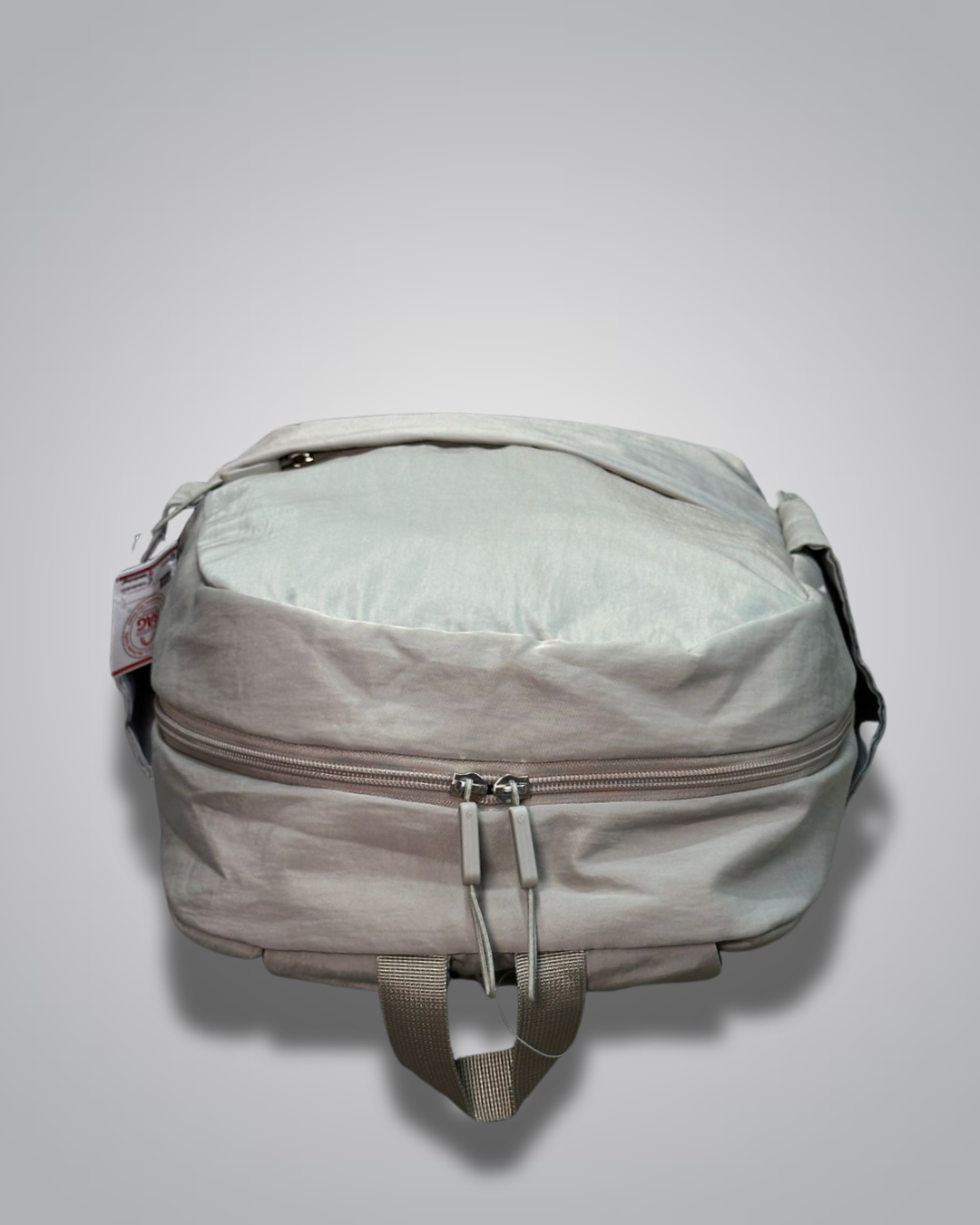 Light gray backpack with a visible brand tag on a light gray background- valentini impex
