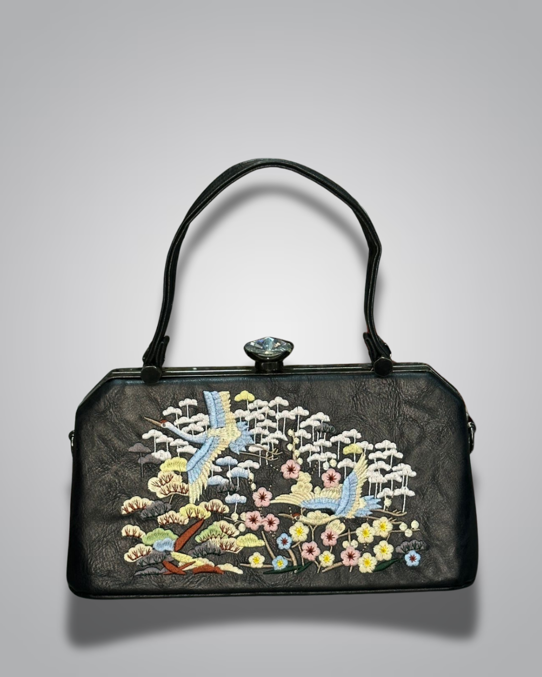 Black handbag with floral embroidery on a gray background-Valentino Impex
