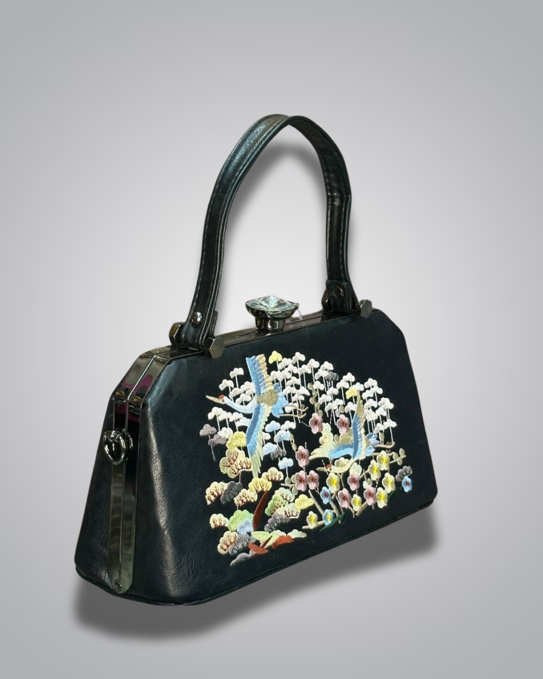 Black handbag with floral embroidery on a gray background-Valentino Impex