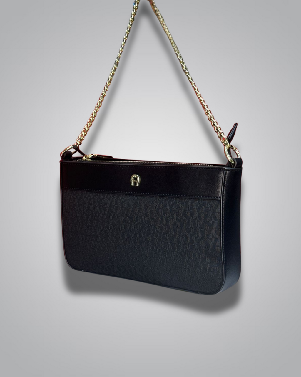 Black handbag with gold chain strap on a gray background- Valentino Impex