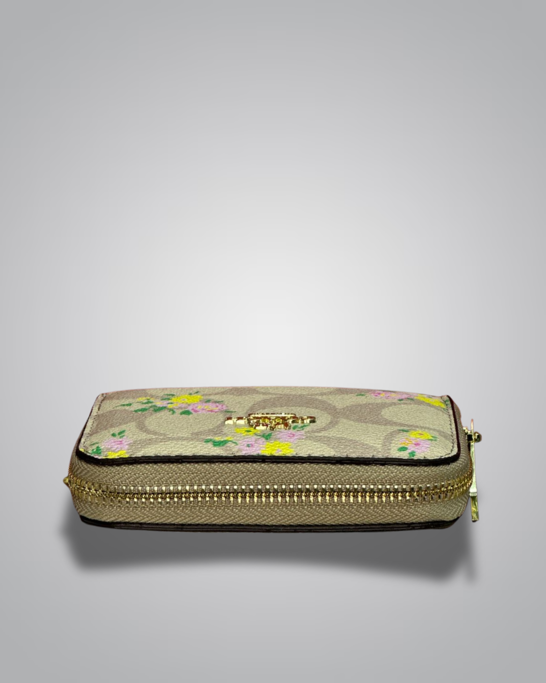 view of Coach Signature Floral Zip Wallet in beige with yellow and pink flower accents- Valentino Impex
