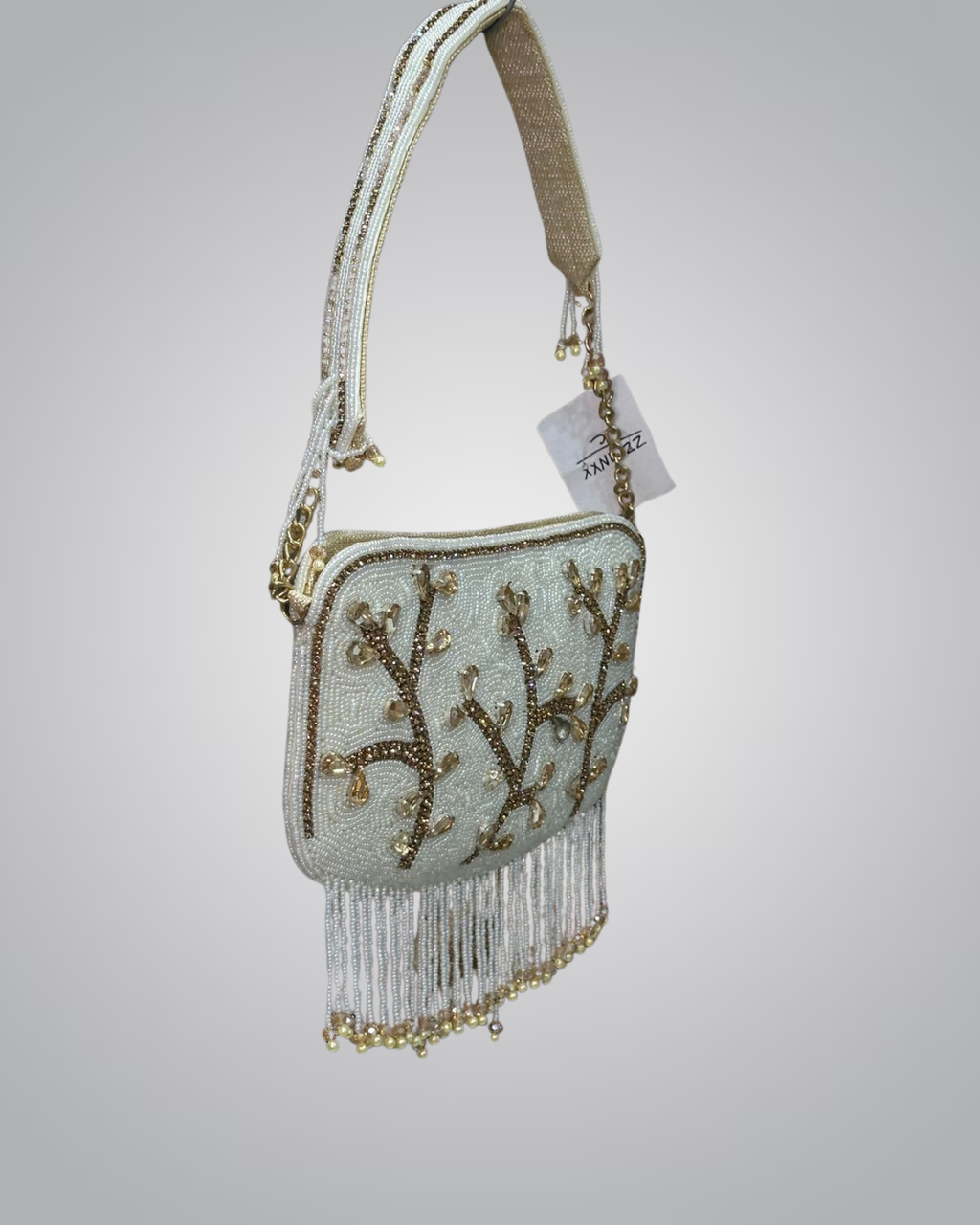Beaded handbag with coral design and fringes on a light gray background