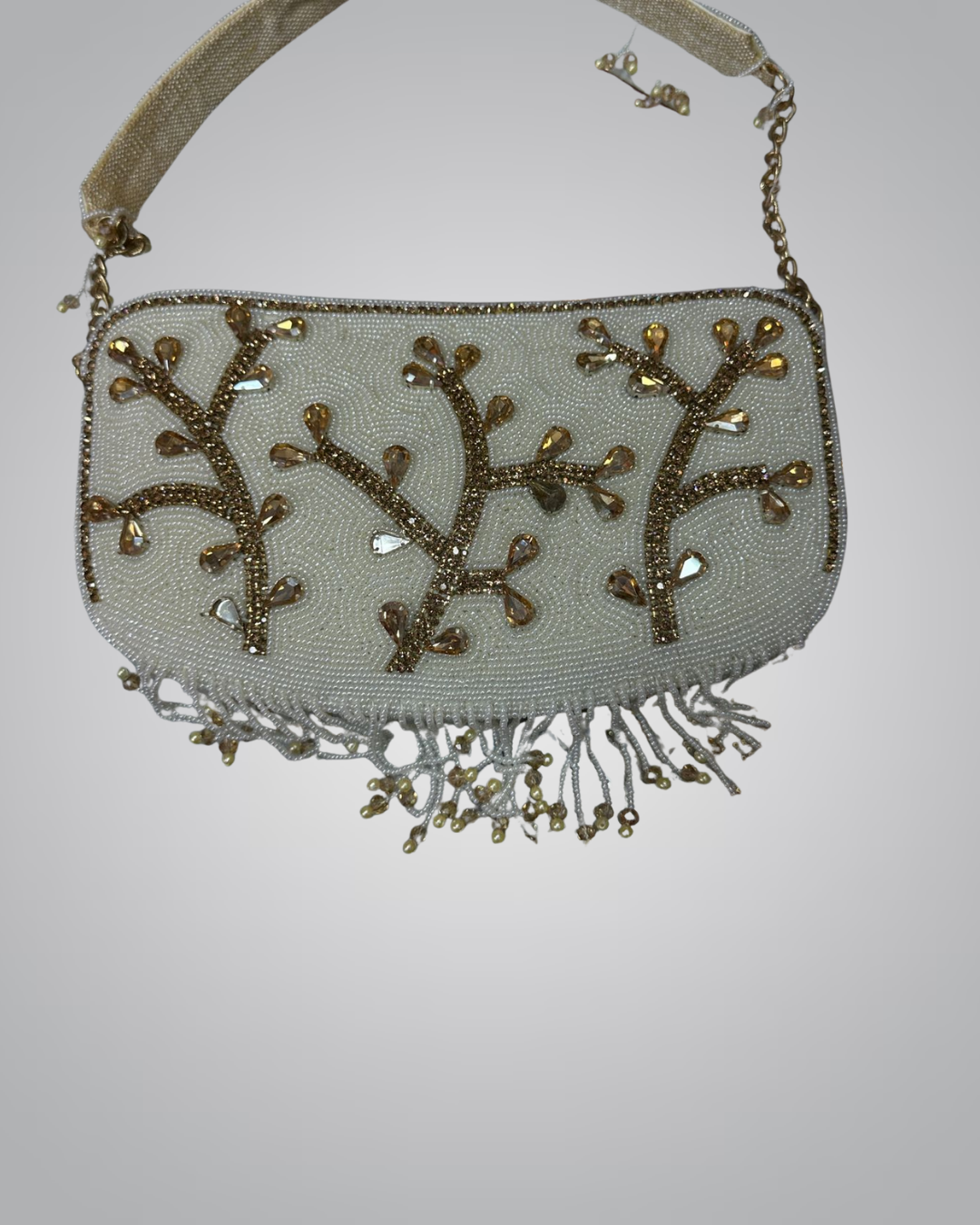 Beaded handbag with floral patterns and fringe on a light gray background
