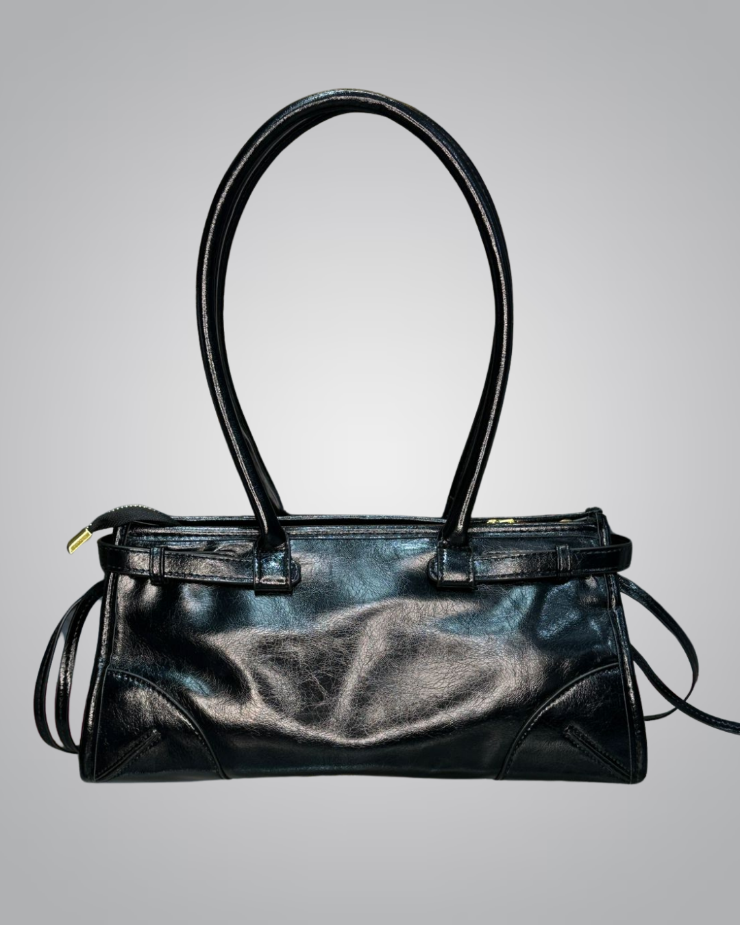 Black leather handbag on a gray background