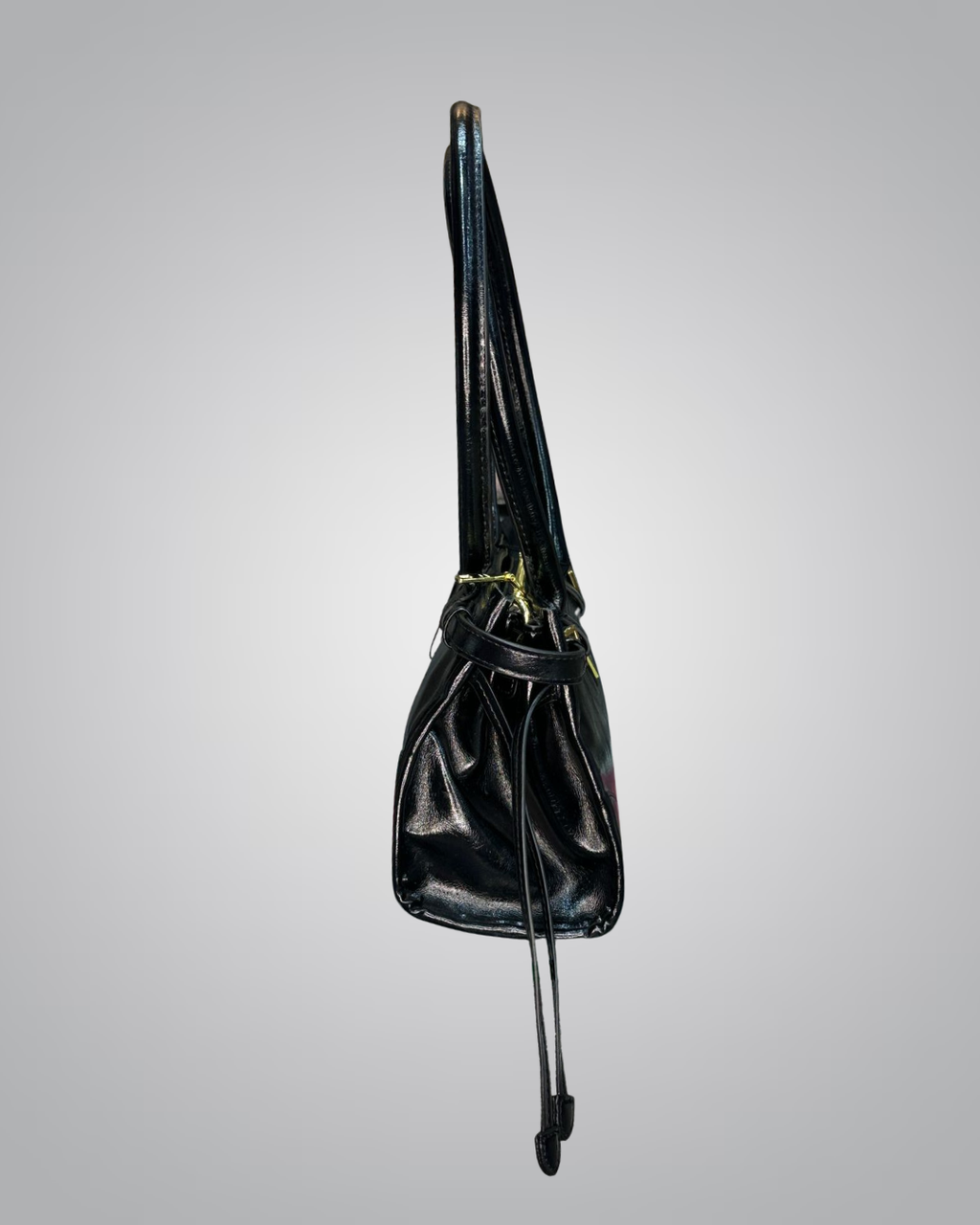 Black leather bag with a strap on a gray background