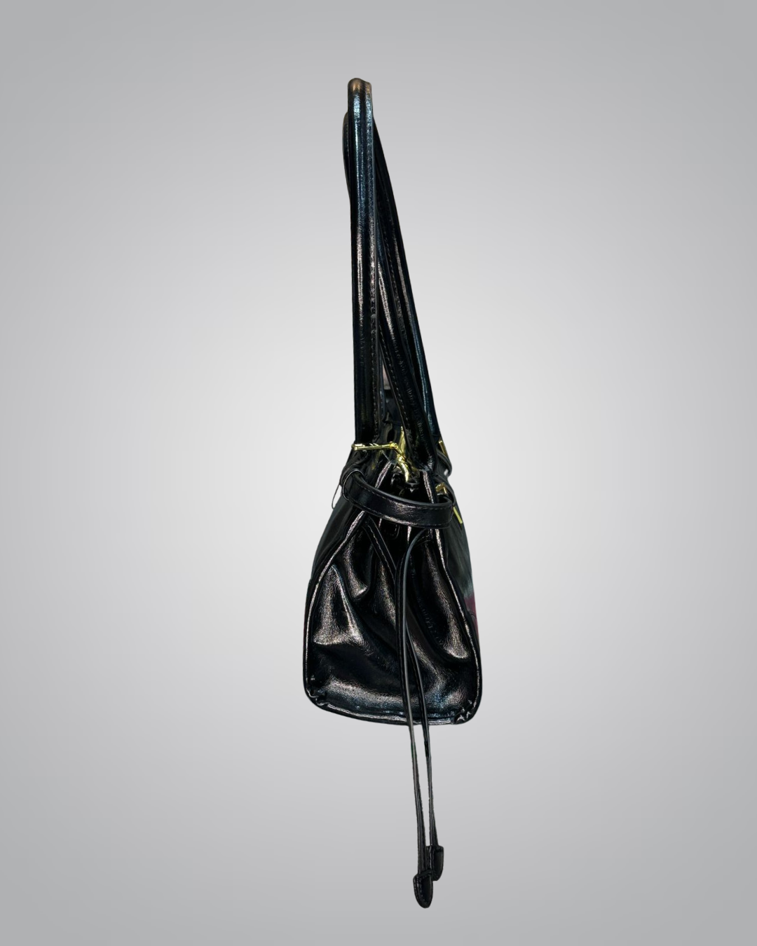 Black leather bag with a strap on a gray background