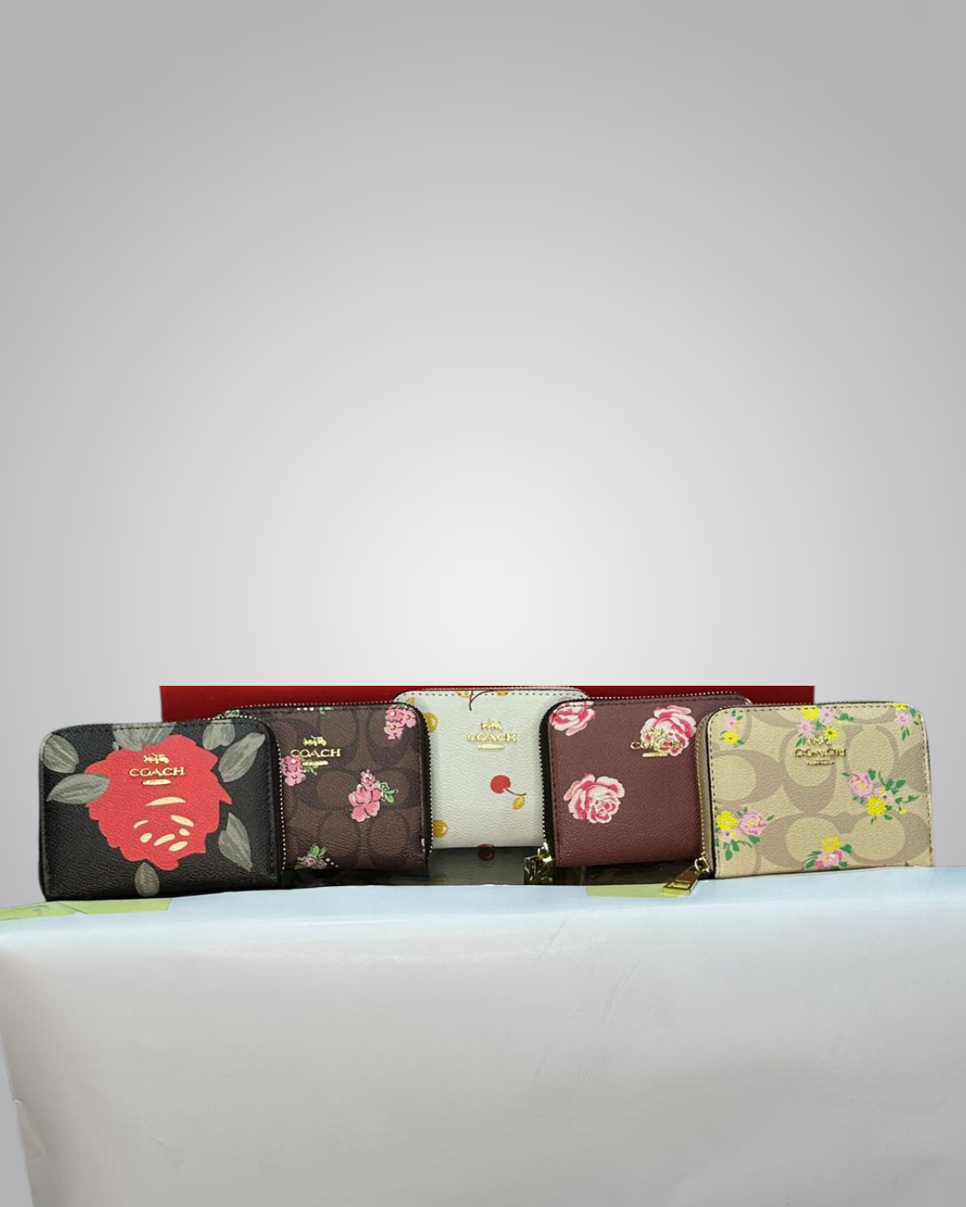 Set of floral-patterned wallets on a light gray background- Valentino Impex