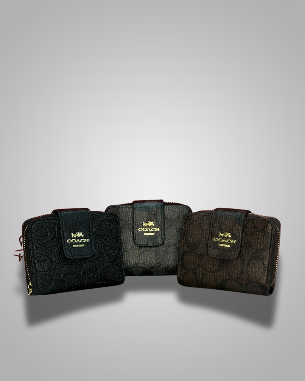 Three Coach wallets displayed on a gray background