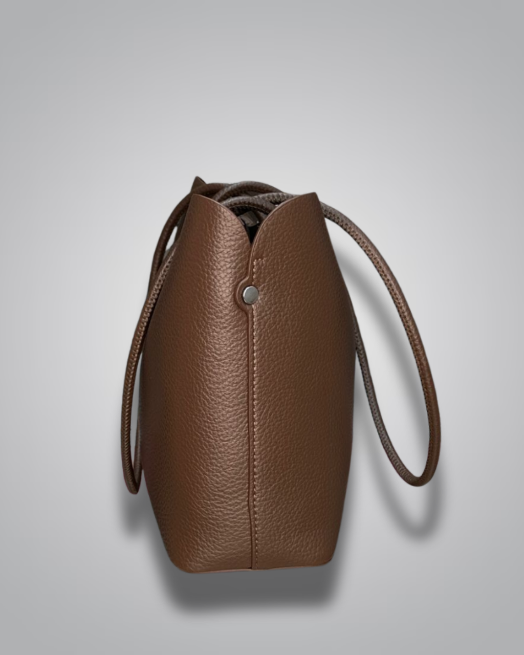 Beige handbag with a sloth keychain on a light gray background- Valentino Impex