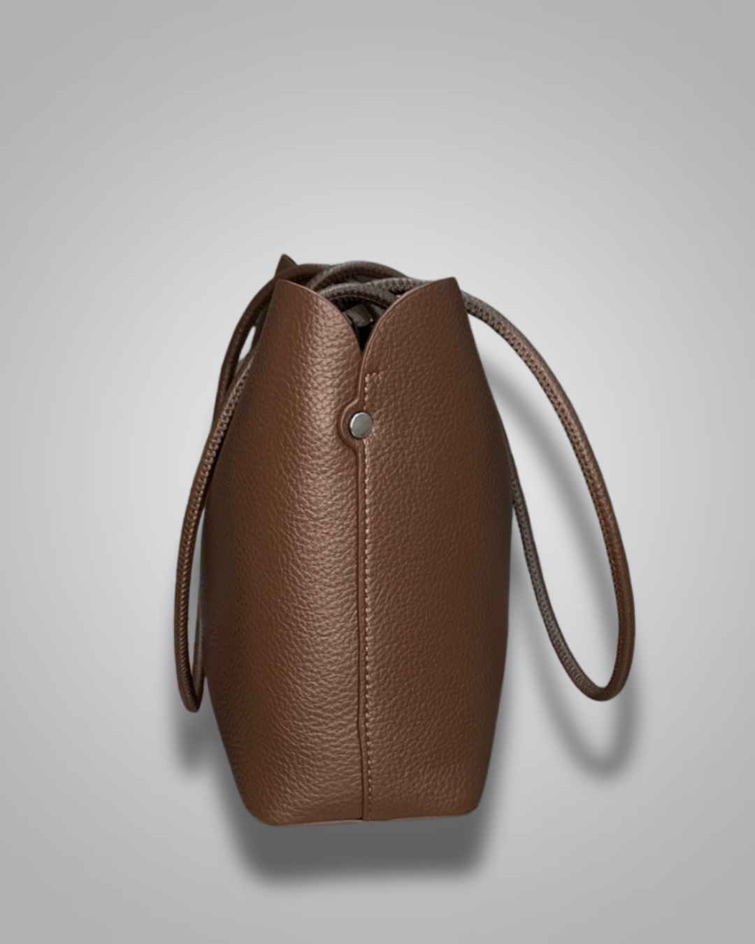 Beige handbag with a sloth keychain on a light gray background- Valentino Impex