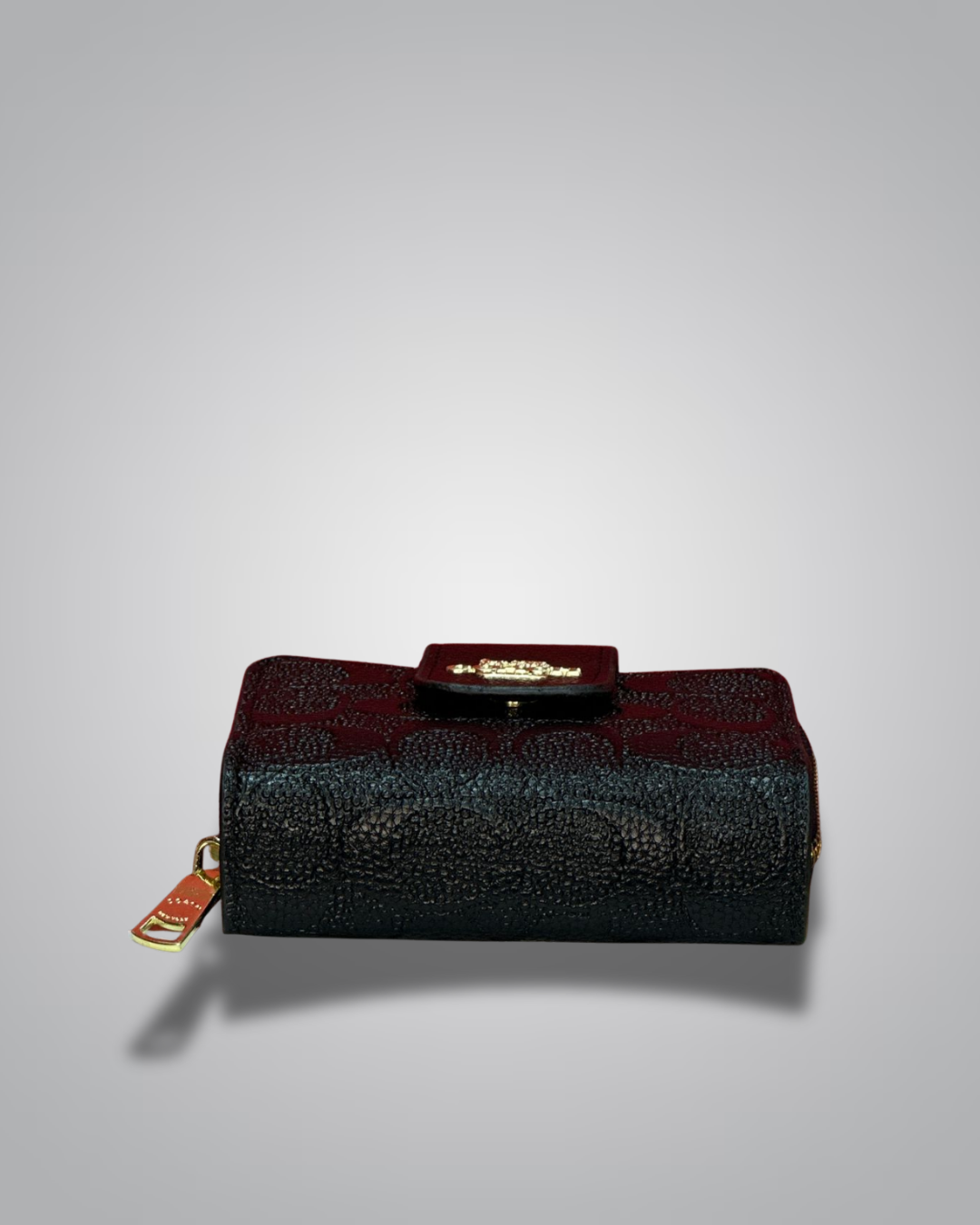 Black textured wallet with gold accents on a light gray background