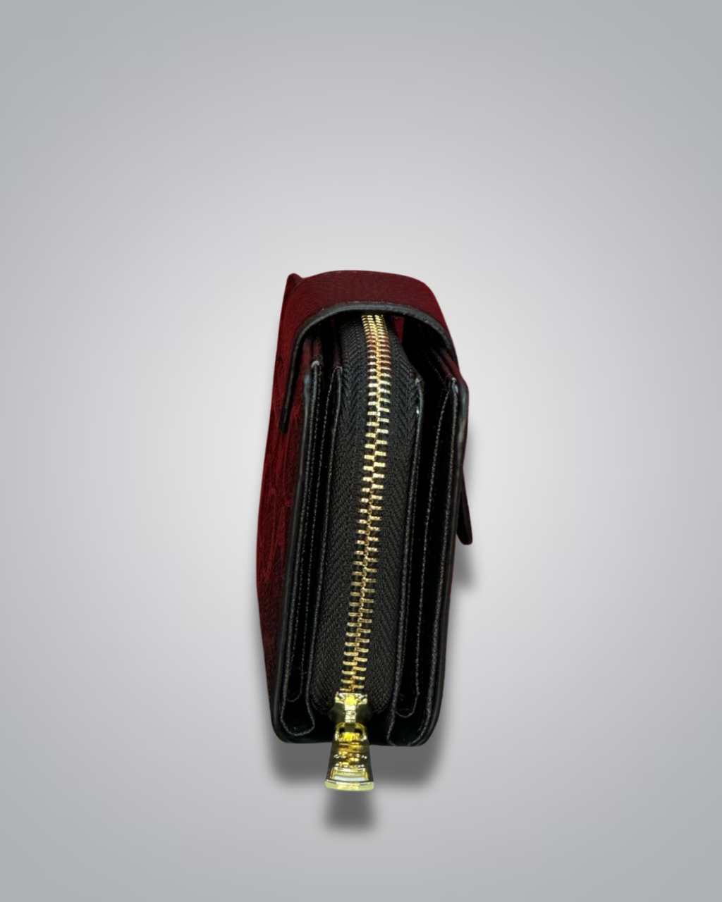 Red and black wallet with a gold zipper on a light gray background