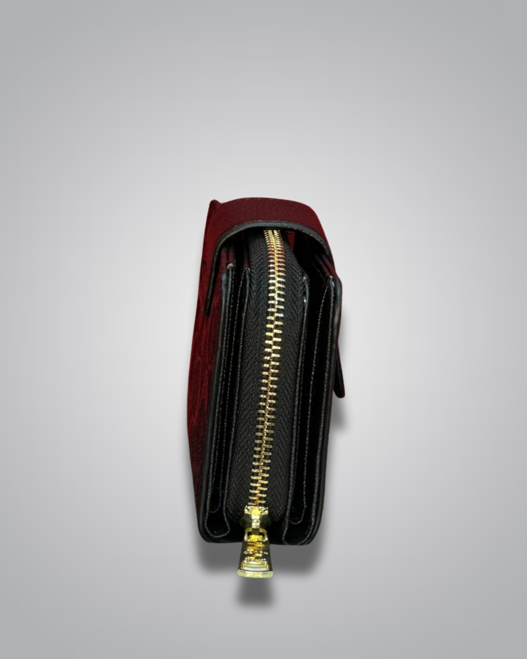 Red and black wallet with a gold zipper on a light gray background