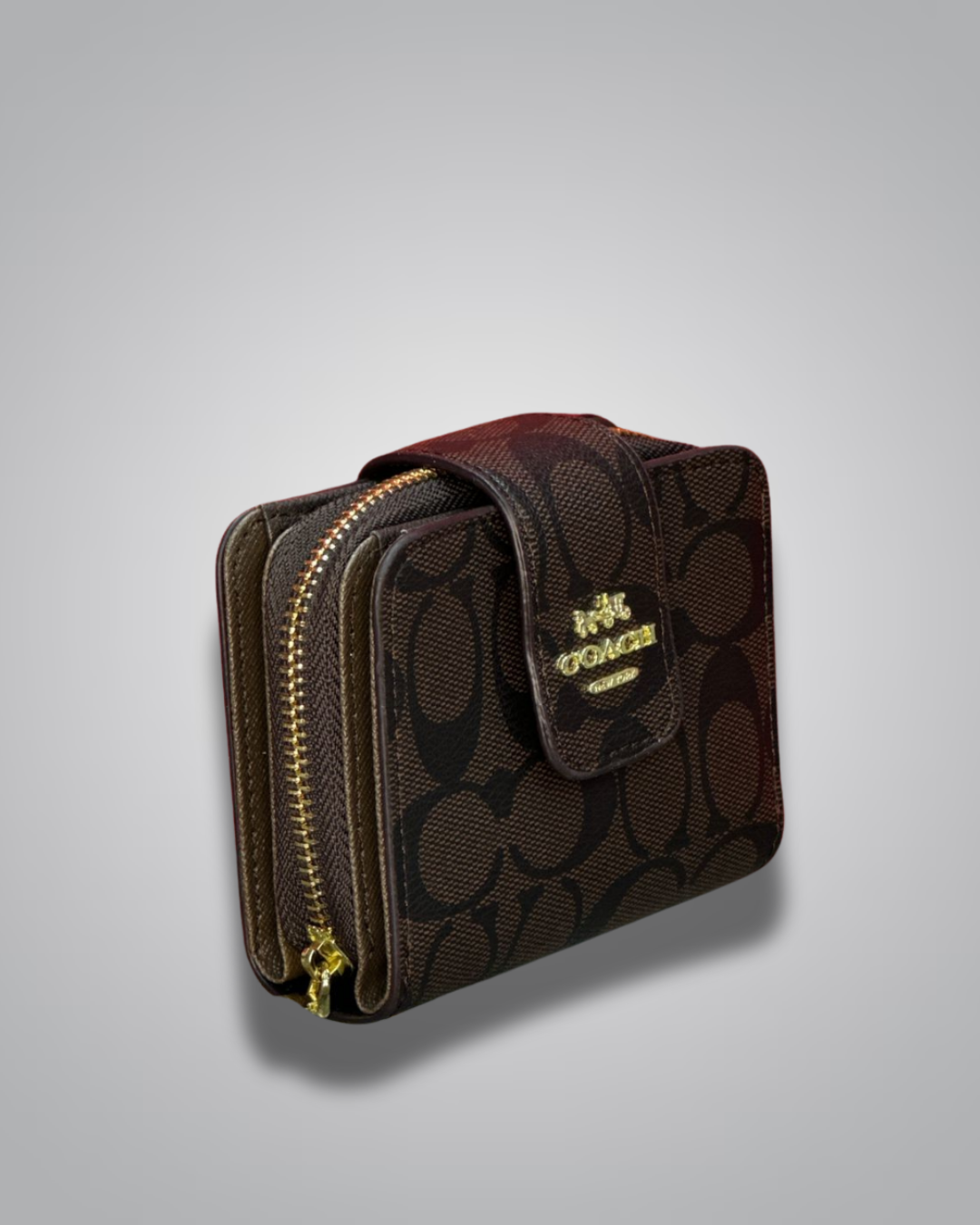 Coach wallet with gold zipper on a gray background