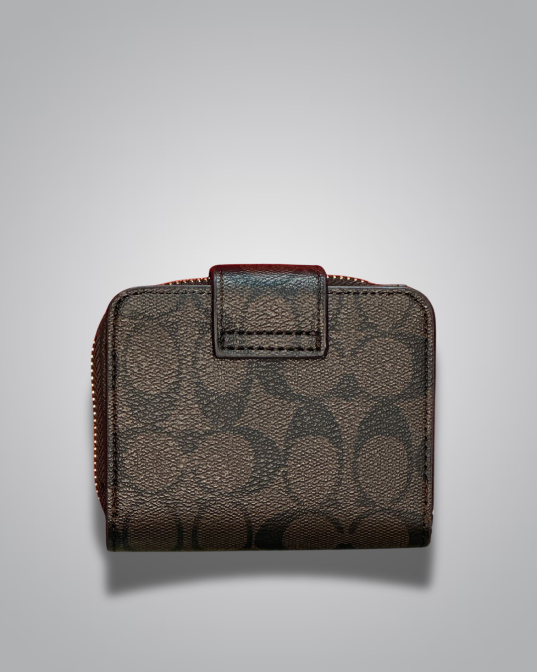 Brown leather wallet with a zipper on a light gray background