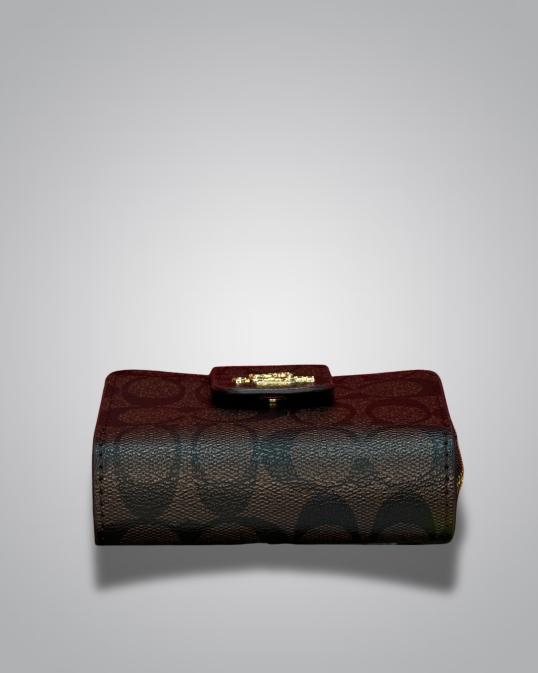 Designer handbag with a prominent brand logo on a light gray background