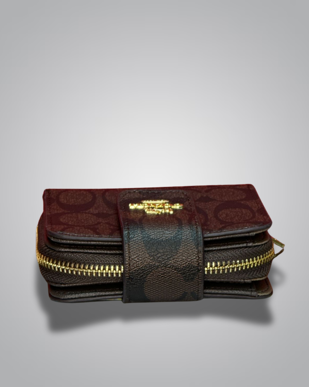 Brown leather wallet with gold zipper on a gray background