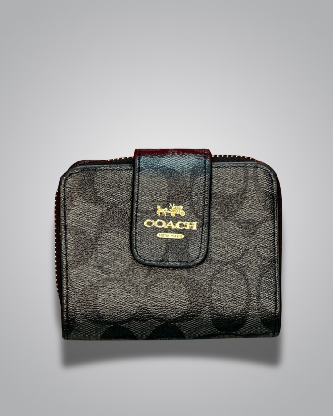 Coach wallet with signature pattern on a gray background