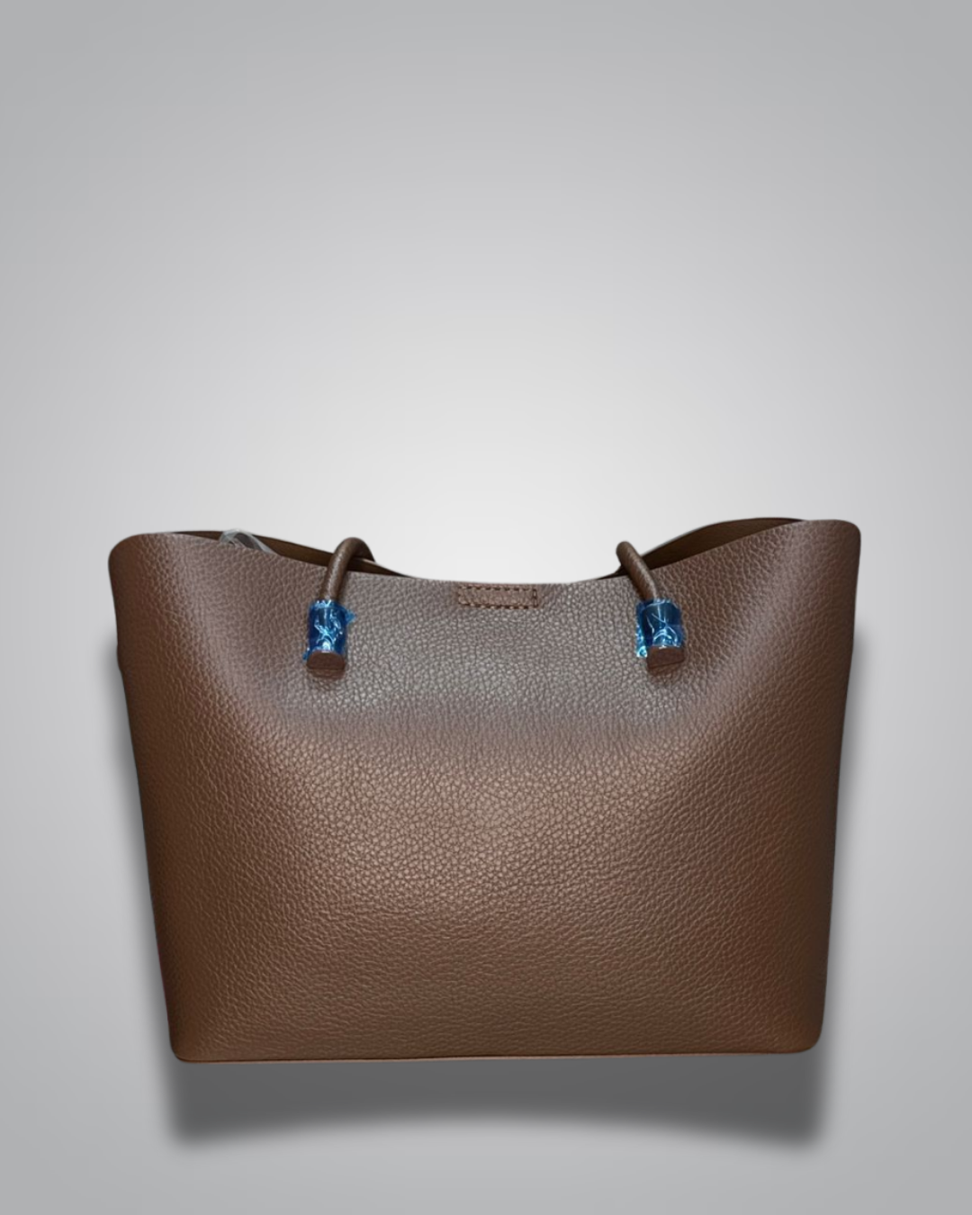 Beige handbag with a sloth keychain on a light gray background- Valentino Impex