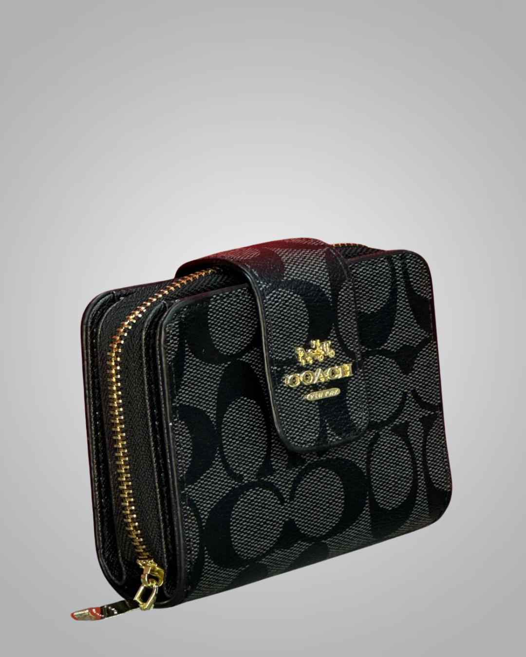 Black patterned wallet with gold zipper on a gray background