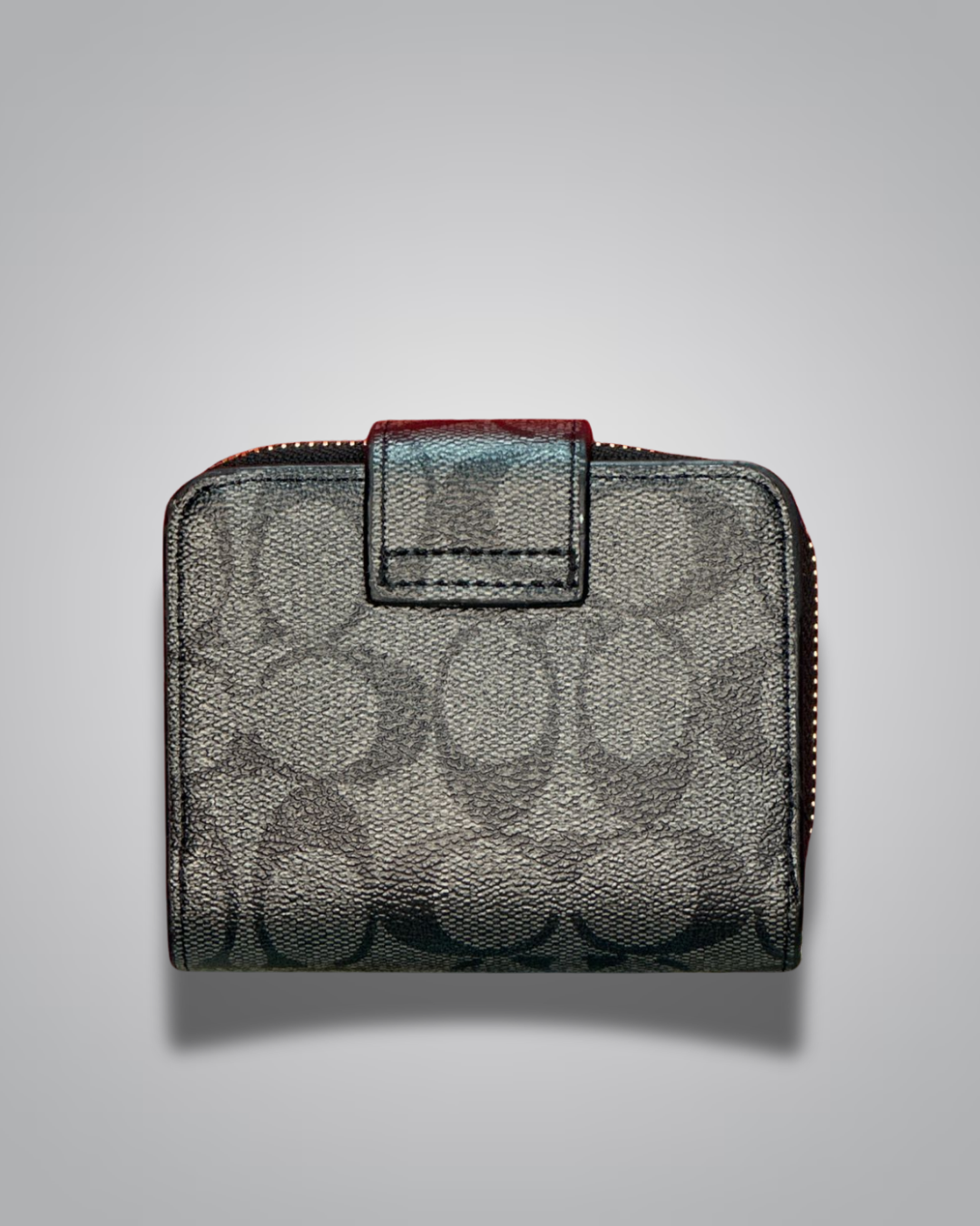 Black patterned wallet with red zipper on a gray background