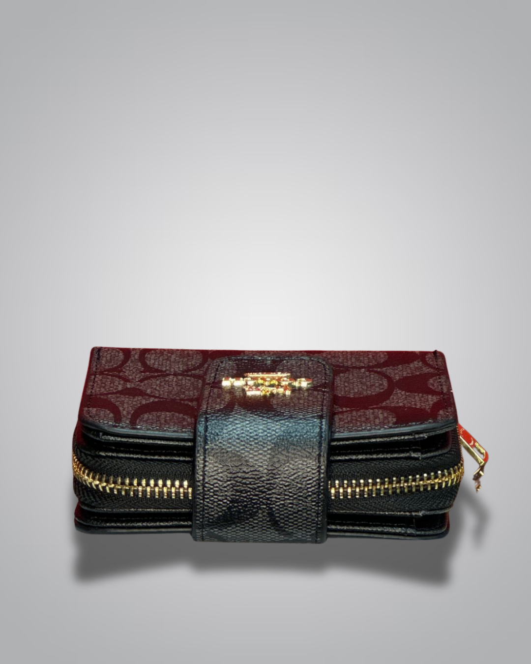Black and red patterned wallet with gold zipper on a gray background