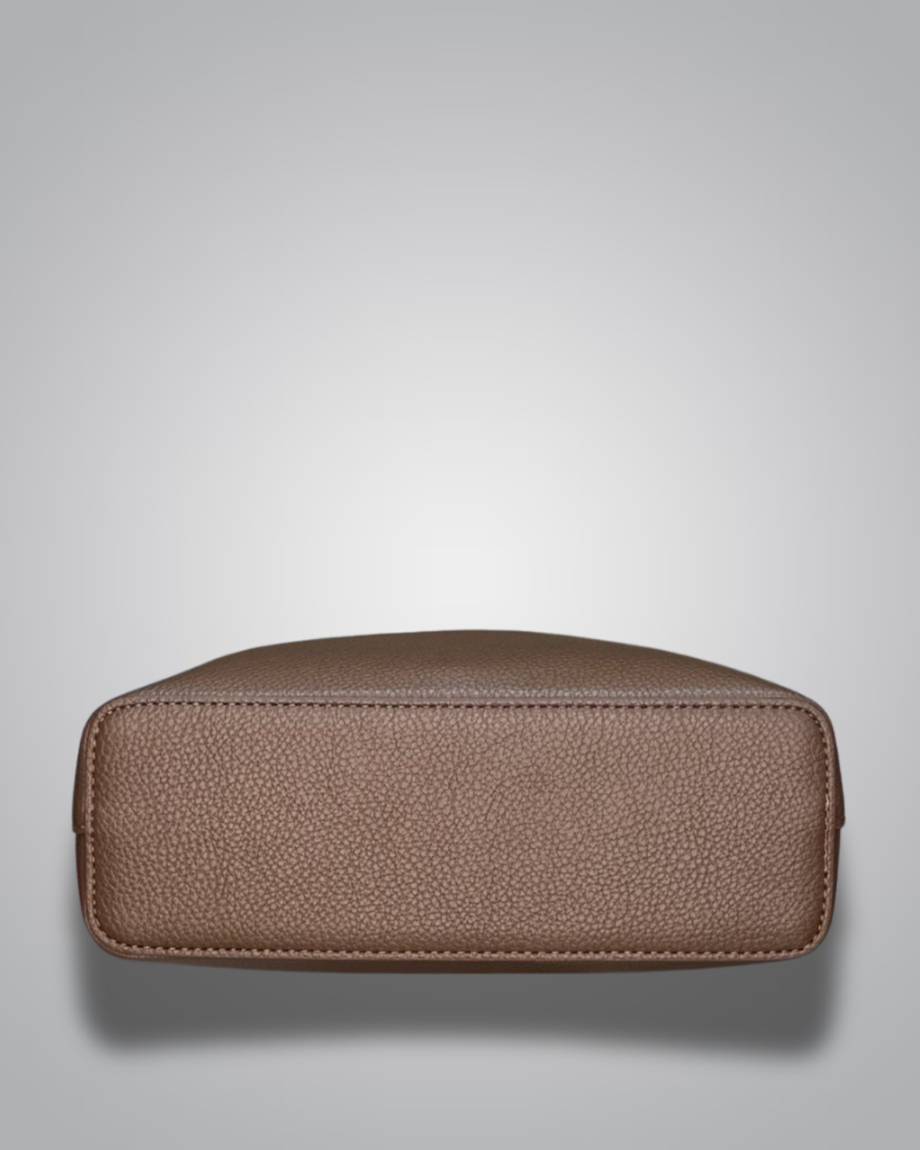 Beige handbag with a sloth keychain on a light gray background- Valentino Impex