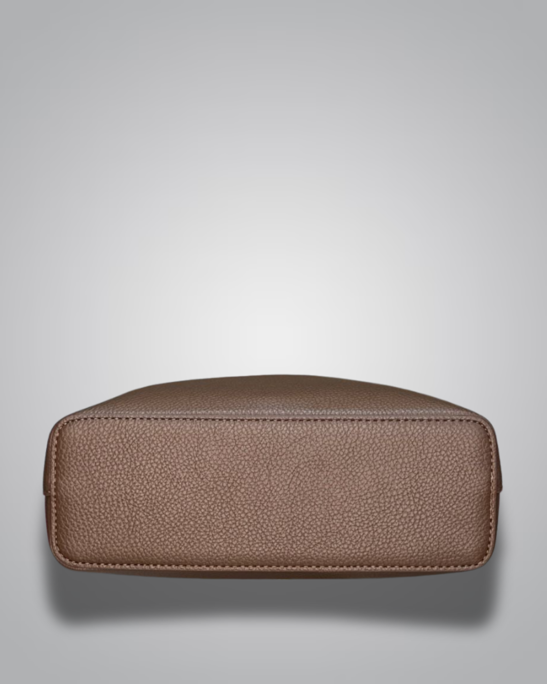 Beige handbag with a sloth keychain on a light gray background- Valentino Impex