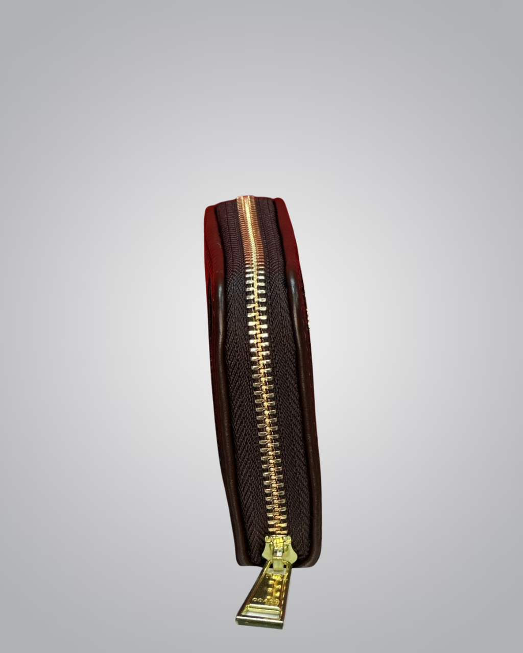 Brown leather wallet with gold zipper on a light gray background