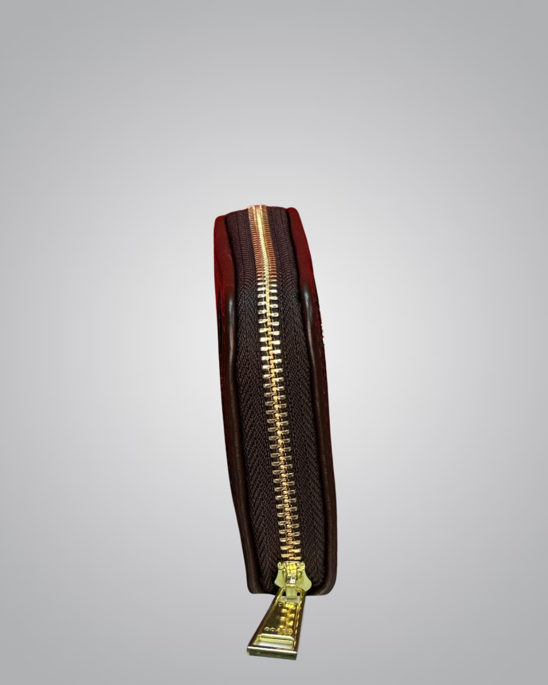 Brown leather wallet with gold zipper on a light gray background