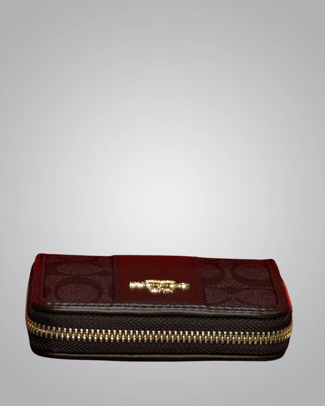 Black and red zippered pouch with gold zipper on a gray background