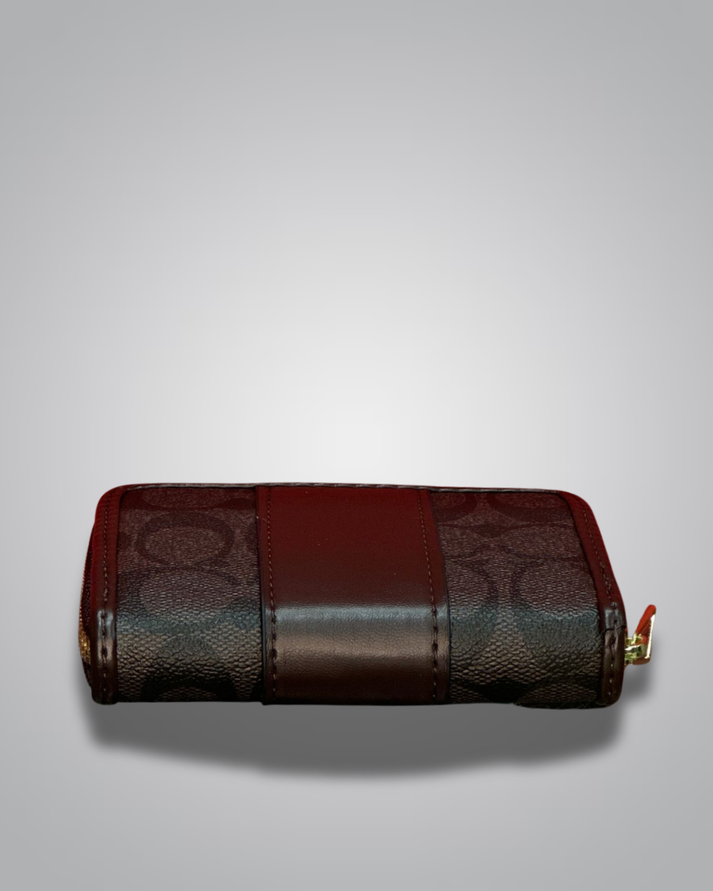 Brown leather wallet with gold accents on a light gray background