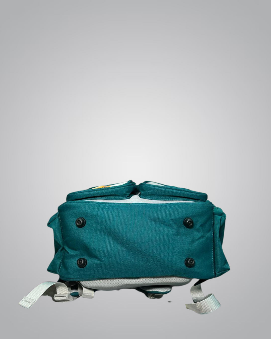 Teal backpack with black buttons on a gray background