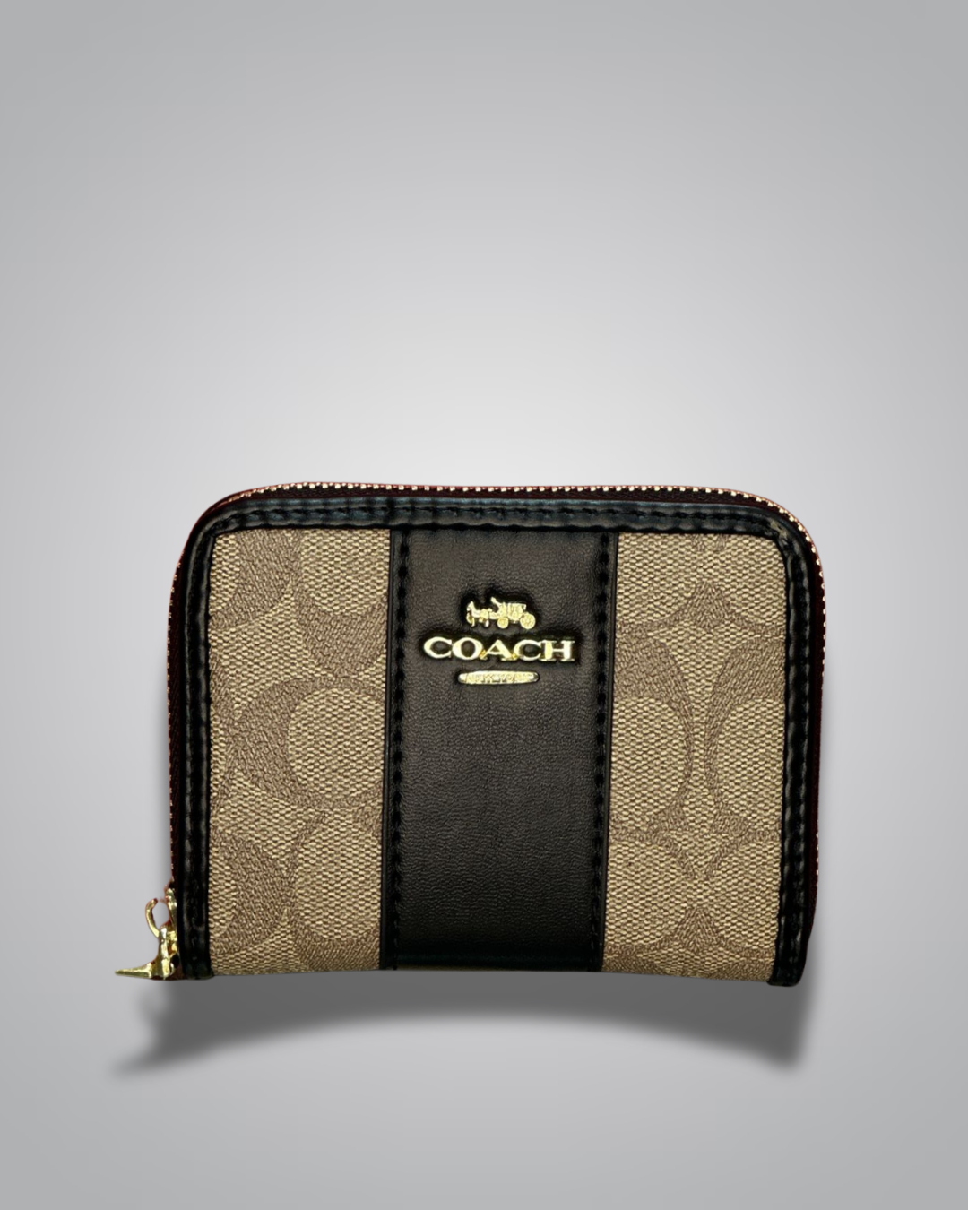 Coach wallet with gold and black design on a gray background