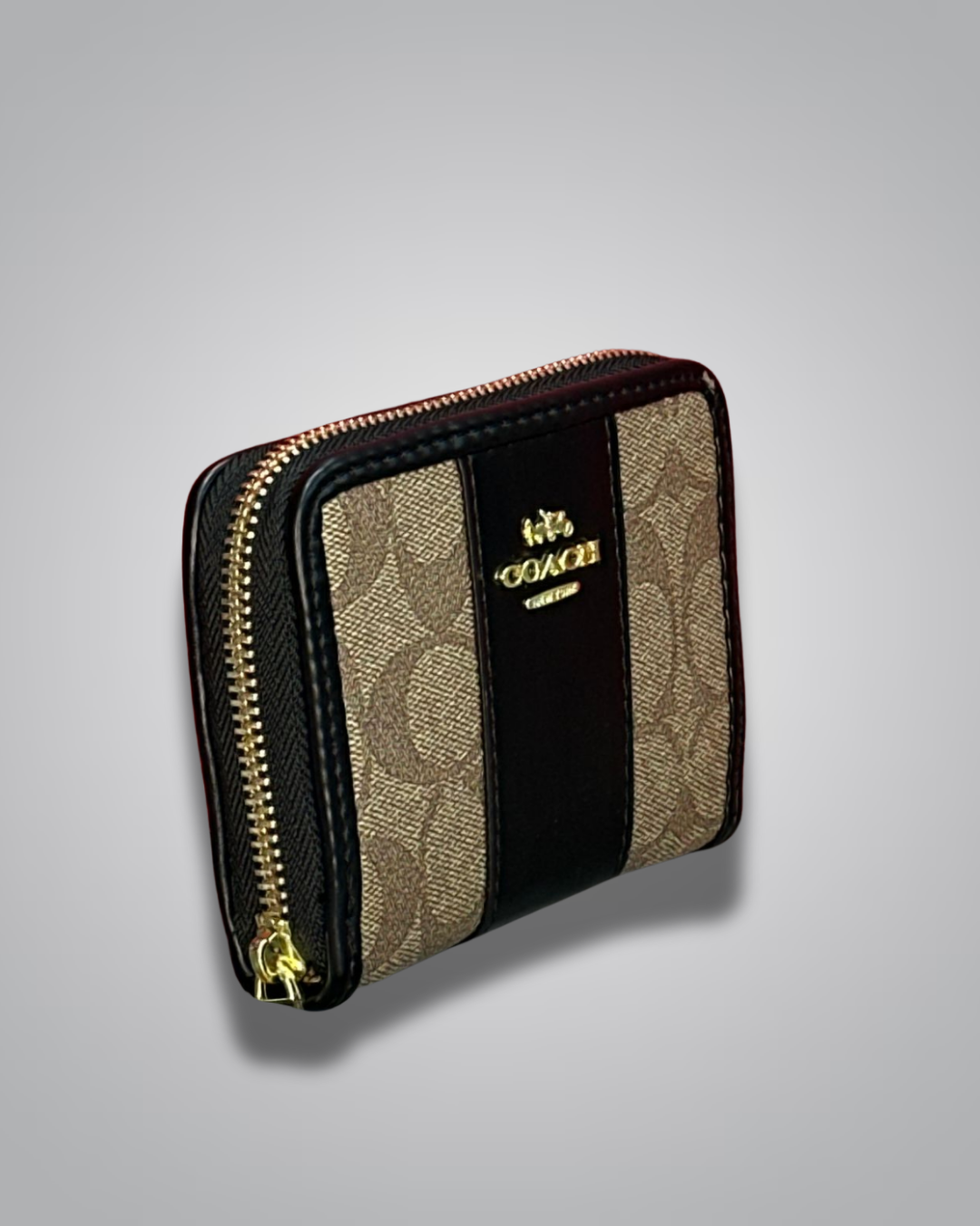 Coach wallet with black and beige design on a gray background
