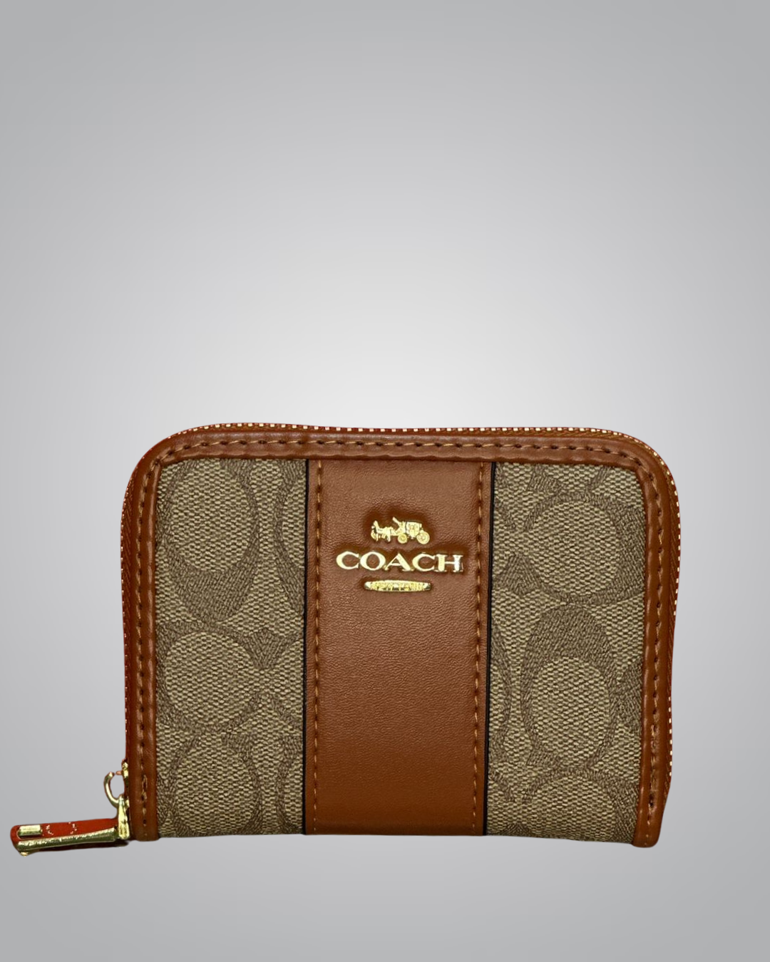 Coach wallet with brown and beige pattern on a gray background