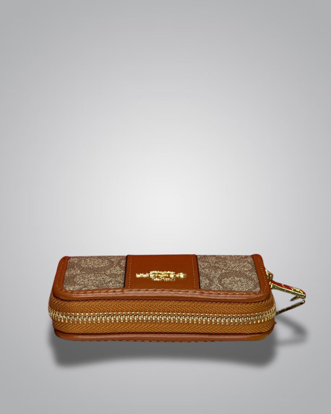 Brown and beige wallet with gold accents on a light gray background