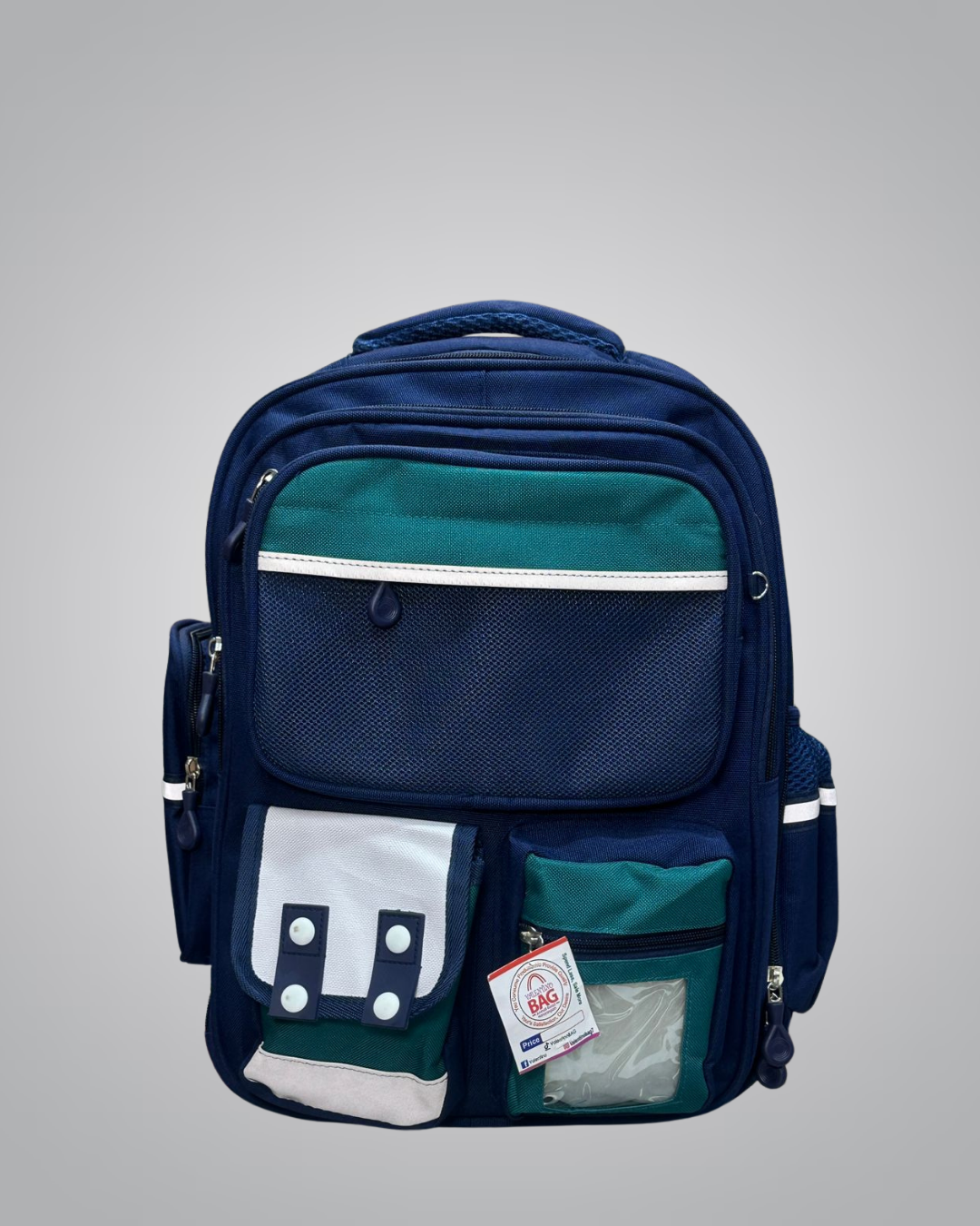 Navy blue and green backpack with multiple pockets on a gray background
