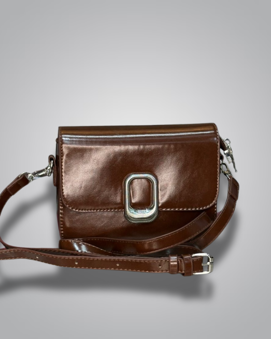 Brown leather handbag with a silver buckle on a gray background- Valentino  Impex