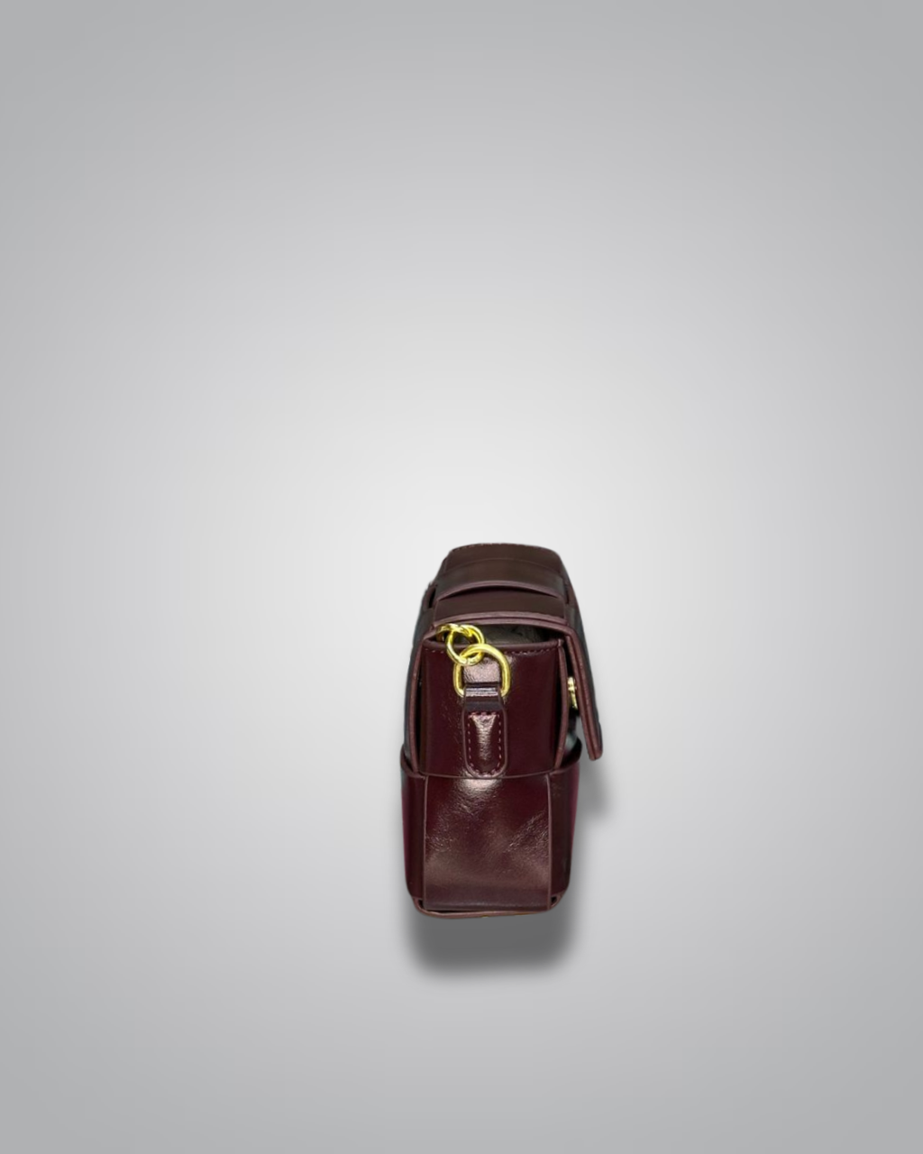 Brown leather bag with gold zipper on a light gray background- Valentino Impex