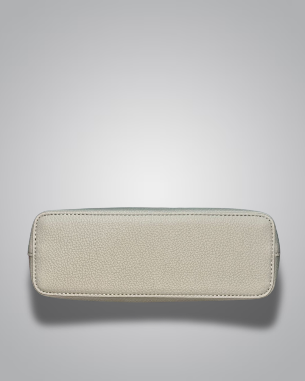 Beige handbag with a sloth keychain on a light gray background- Valentino Impex