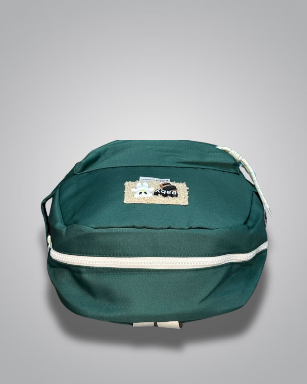 Green backpack with a patch on a gray background- Valentino Impex