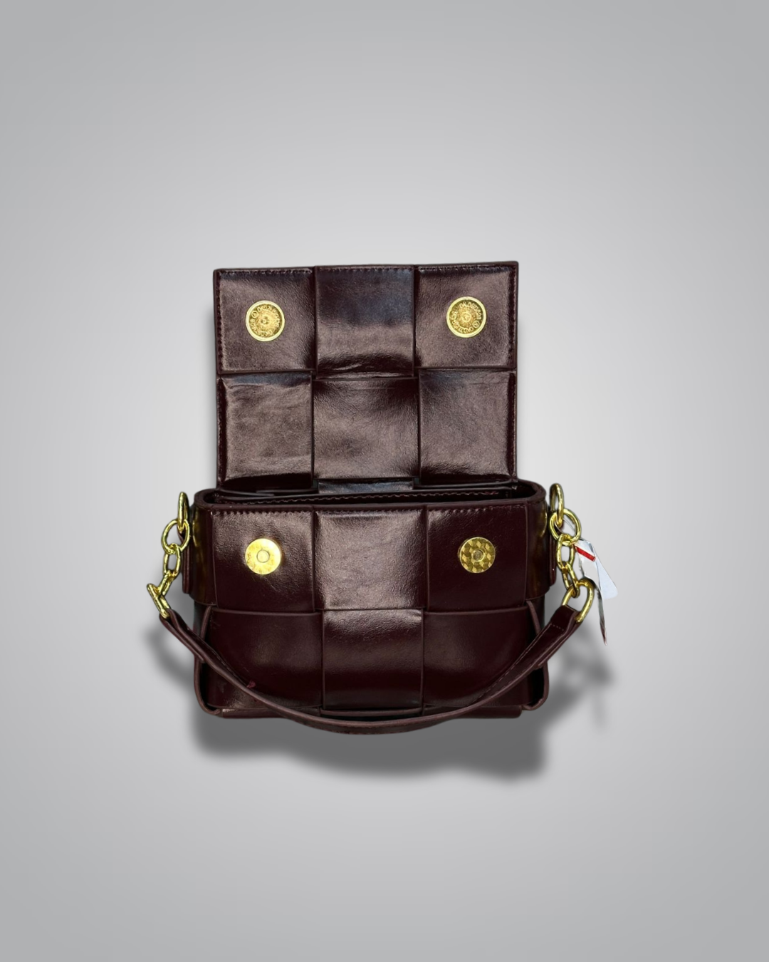 Brown leather handbag with gold accents on a gray background- Valentino Impex