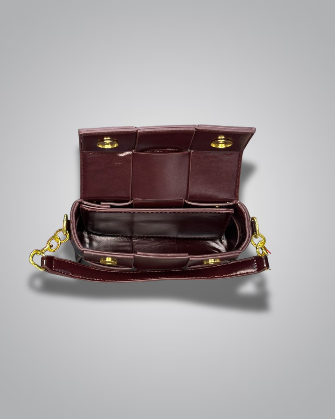 Brown leather handbag with gold accents on a gray background- Valentino Impex