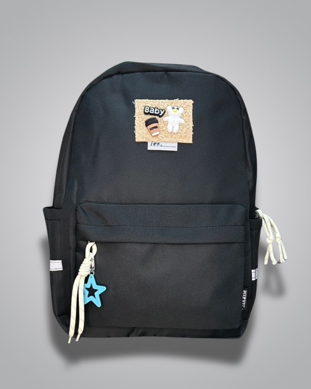 Black backpack with decorative patches and a blue star charm on a gray background- Valentino Impex