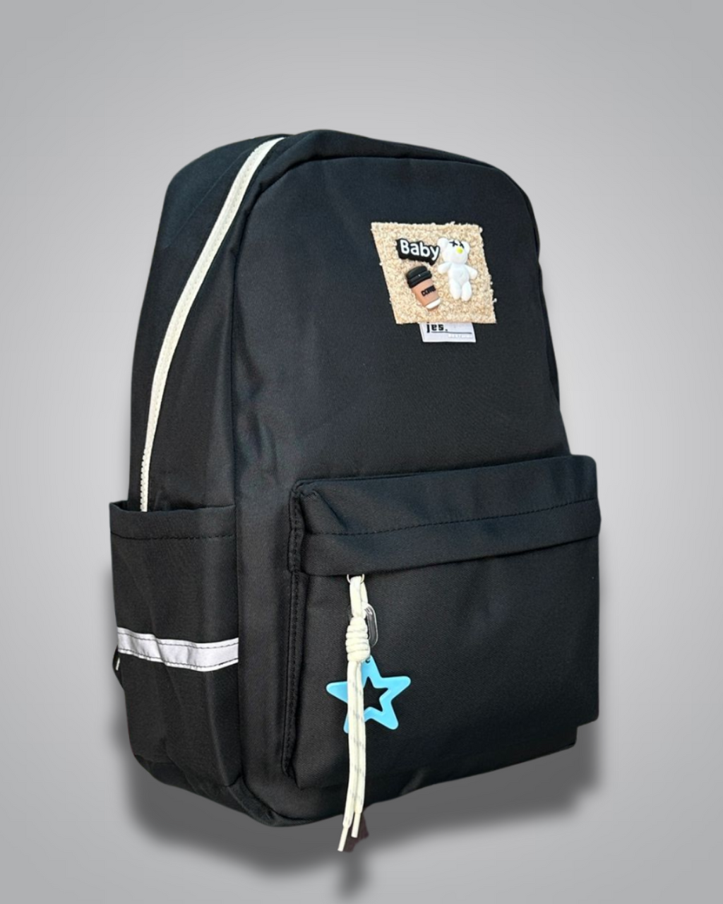 Black backpack with decorative patches and a blue star charm on a gray background- Valentino Impex